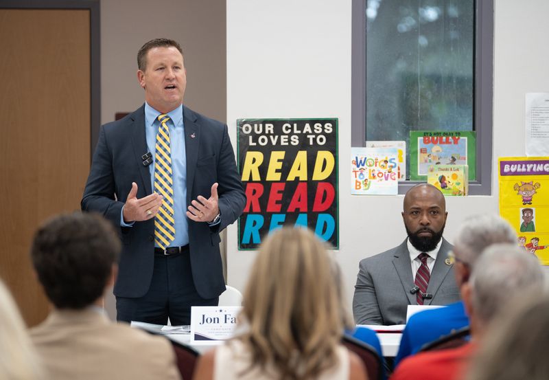 Trei McMullen, right, listens as fellow Republican candidate for Florida House District 2 Jon Fay talks during at debate hosted by the Warrington Revitalization Committee at the Lexington Terrace Community Center in Pensacola on June 30, 2026.