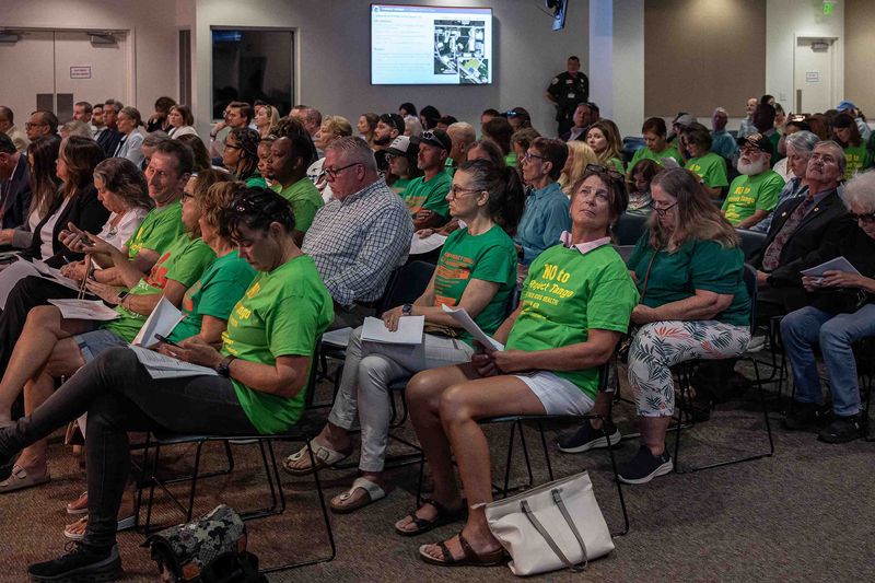 Opponents of Project Tango watch proceedings during the zoning commission meeting at the main offices in Vista Center on Jog Road in unincorporated Palm Beach County, Fla., on July 2, 2026.