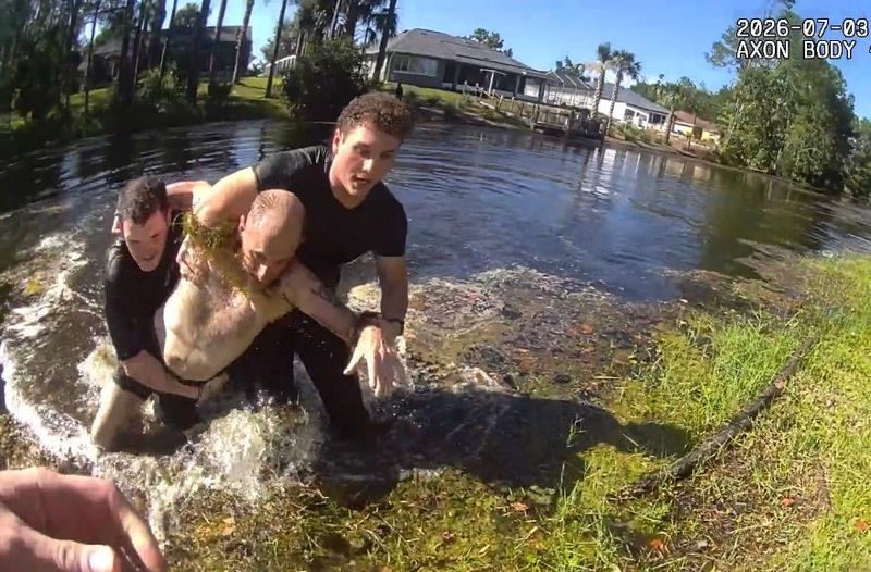 Flagler County Sheriff's deputies pull Ryan McMinn out of a Palm Coast canal after the 47-year-old jumped into the water to escape them. McMinn swam for about an hour while deputies ordered him to get out of the canal, July 3, 2026, according to FCSO.