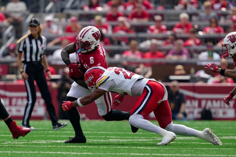 Sep 20, 2025; Madison, Wisconsin, USA;  Wisconsin Badgers running back Darrion Dupree (6) is tackled by Maryland Terrapins defensive back Jalen Huskey (22) during the second quarter at Camp Randall Stadium. Mandatory Credit: Jeff Hanisch-Imagn Images