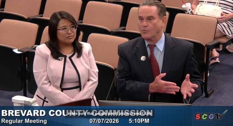 Adrianna Tran, director of Government Relations at Community Legal Services, flanks Joe Colombo, a Melbourne attorney, as he speaks Tuesday July 7, at the Brevard County Commission meeting. Commissioners made a proclamation honoring the 60th anniversary of the nonprofit, which provides free legal help to low-income families.