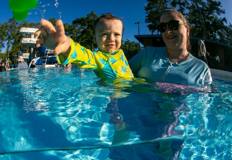Arianna Ospino and Benjamin  enjoy swim lessons at H. Spurgeon Cherry Pool in Gainesville on Wednesday, July 8, 2026. The City of Gainesville's aquatics program offers classes ranging from Aqua Babies for children ages 6 to 36 months with a parent in the water to Learn to Swim classes for older children. Summer lessons at Cherry Pool are held Monday through Thursday in two-week sessions, with Fridays reserved for weather make-up days. The next session begins July 20 and continues through July 30.
[Alan Youngblood/Gainesville Sun]