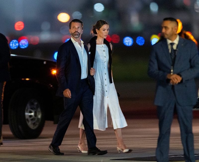 Donald Trump Jr., left, and wife Bettina  Anderson arrive at Donald J. Trump International Airport on July 9, 2026 in West Palm Beach, Florida.