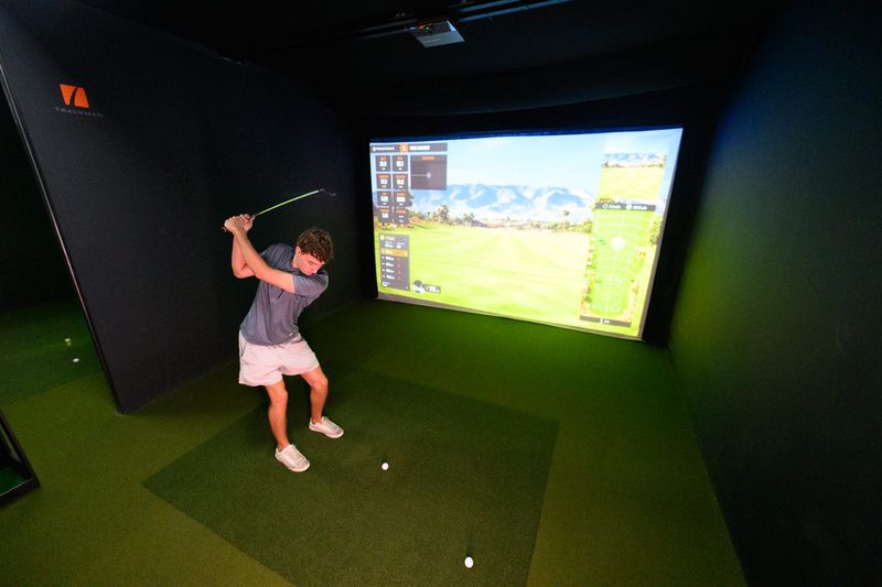 Kylan Young tries his hand on the big simulator at GolfSim24 in Port Orange.