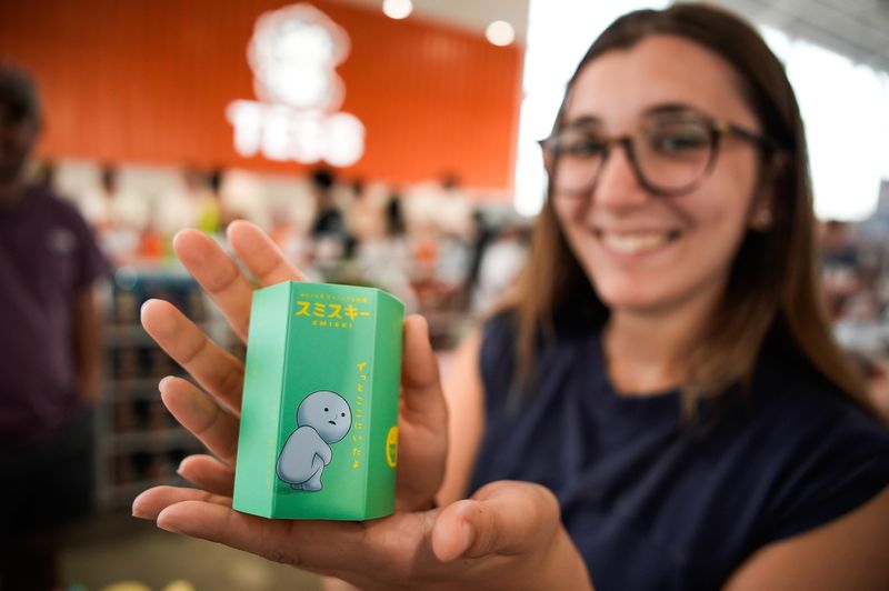 Emma Arciola shows off her blind box during TESO Life’s grand opening Friday, July 10, 2026 in the Arlington area of Jacksonville, Fla. A blind box is a sealed package containing a random collectible toy or item from a specific themed series.