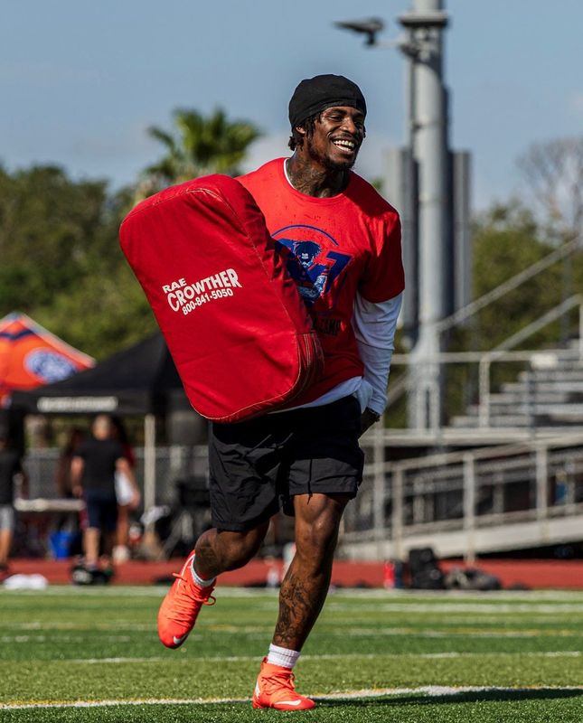 Buffalo Bills safety and Super Bowl champion CJ Gardner-Johnson holds a pad during a drill at his youth football camp in New Smyrna Beach on July 12, 2026, at New Smyrna Beach Sports Complex.