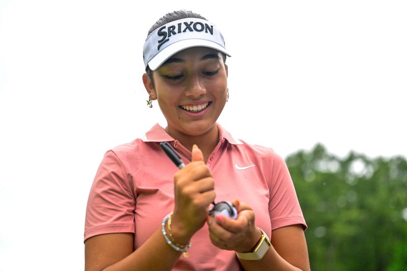 Sofia Rivera of St. Augustine smiles while marking her golf ball before playing in the first round of stroke play of the 2026 U.S. Girls' Junior at Old Chatham Golf Club in Durham, N.C. on July 13, 2026. Rivera shgot 69-71 and qualified for the round of 64 in match play, beginning on July 15.