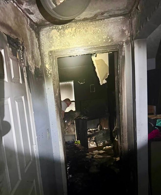 An investigator works to determine cause of fire at a Deland home. Two officers suffered smoke inhalation as they searched for a boy, who turned out not to be in the house.
