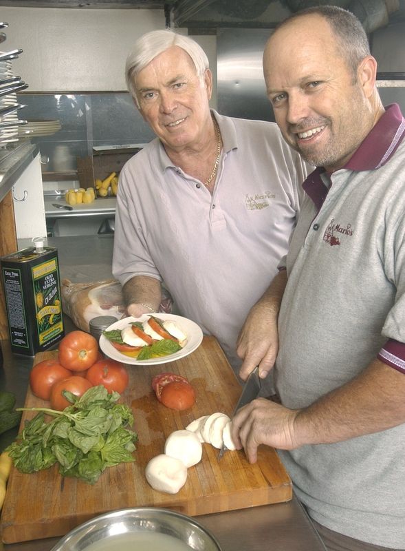 Mario Scarpa, left, and his son Glenn of Mario's Italian Restaurant, prepare the appetizer Insalata Caprese at the restaurant. August 7, 2003.