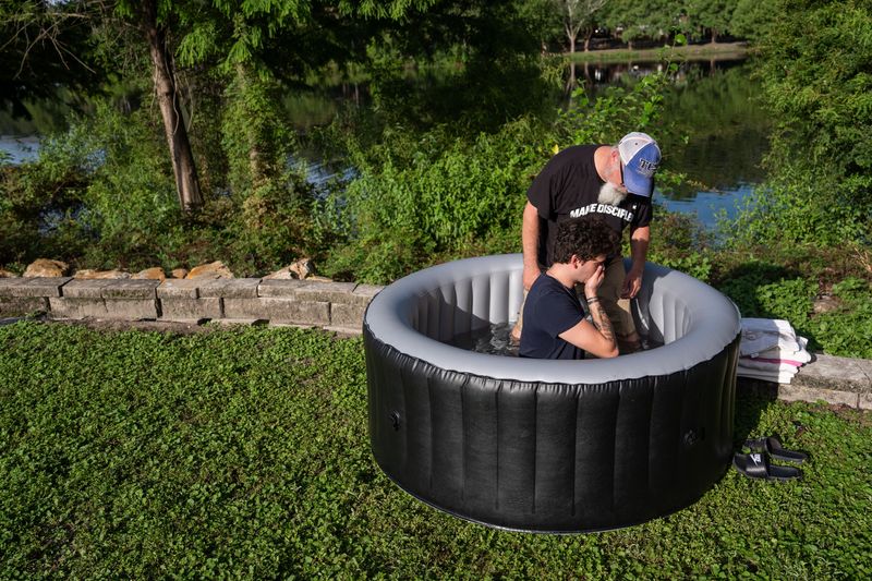 Lakeview Baptist pastor Rich Day baptizes Dean Bryant at Lake Ella on Wednesday, July 15, 2026.