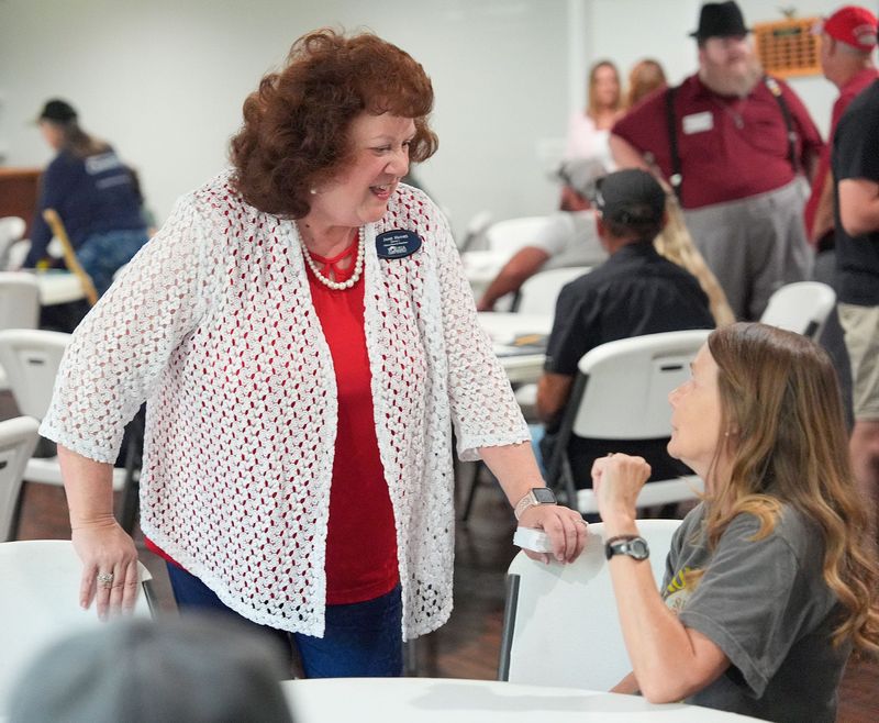 Jamie Haynes, a candidate for the Volusia County School Board's District 1 seat, speaks to an attendee of a candidates' forum hosted by the West Volusia Patriots on July 15, 2026, at the Elks Club in DeLand.