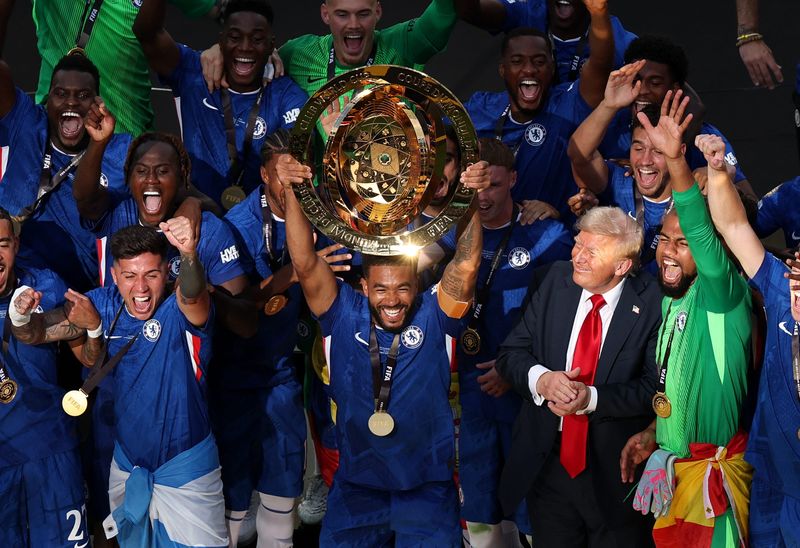 [Subscription Customers Only] Jul 13, 2025; East Rutherford, New Jersey, USA; Chelsea FC defender Reece James (24) lifts the trophy as he celebrates with teammates as U.S. President Donald Trump looks on after the final of the 2025 FIFA Club World Cup at MetLife Stadium. Mandatory Credit: Amanda Perobelli-Reuters via Imagn Images