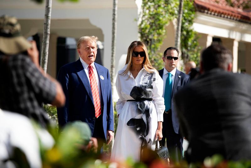 Then-candidate Donald and Melania Trump stand in front of members of the media after casting their votes at the Morton and Barbara Mandel Recreation Center in Palm Beach on presidential primary elections day on March 19, 2024.