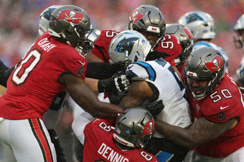 Jan 3, 2026; Tampa, Florida, USA;  Tampa Bay Buccaneers linebacker Sirvocea Dennis (8) and linebacker Yaya Diaby (0) and defensive end Elijah Roberts (95) and defensive tackle Vita Vea (50) tackle Carolina Panthers running back Rico Dowdle (5) in the first half at Raymond James Stadium. Mandatory Credit: Nathan Ray Seebeck-Imagn Images