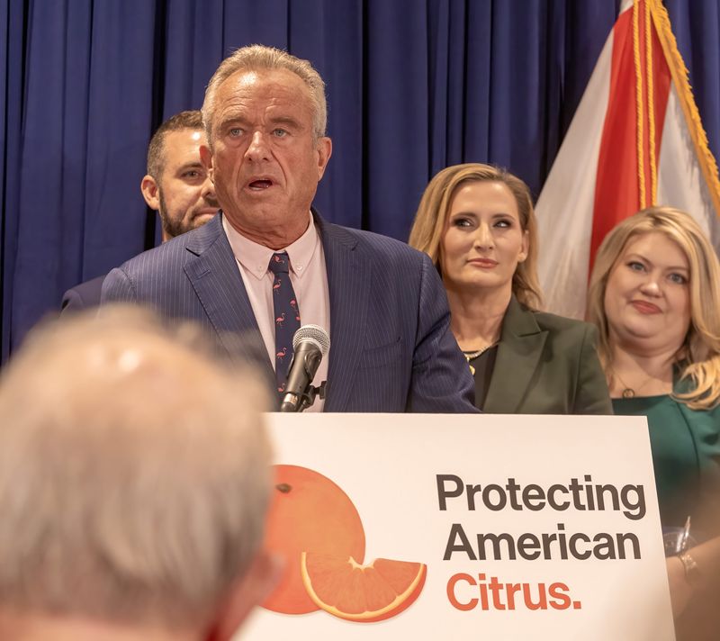 U.S. Secretary of Health and Human Services Robert F. Kennedy Jr. discusses a change in a federal rule on the content of orange juice during a news conference July 17 at Bonnet Springs Park in Lakeland.