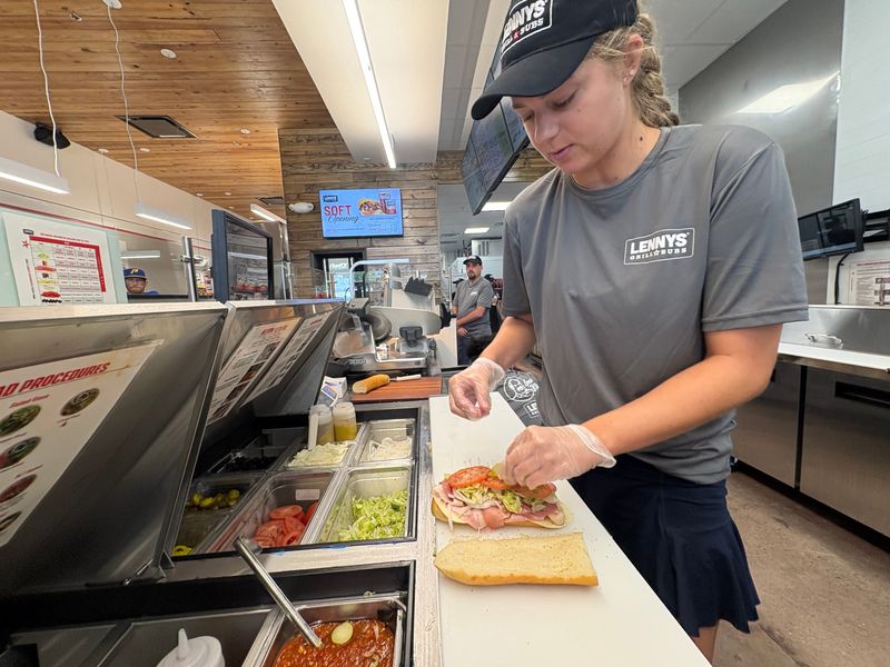 Front-of-house employee Hannah Kussin prepares an order Lennys Grill & Subs, now open in its soft-opening stage at 96 E. Garden St. A grand opening is planned for July 30.