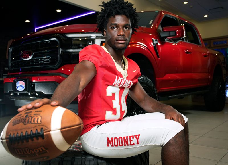 Cardinal Mooney Catholic running back Connail Jackson is a member of the 2026 Herald-Tribune Big 15 college football recruits. Photographed at Sarasota Ford with a 2025 Ford F-150 Lariat in Rapid Red with a 6" BDS lift kit and 22" Vossen wheels.