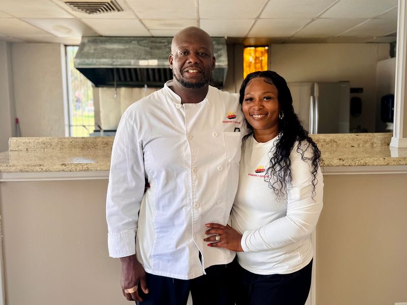 James and Angelique King, husband-and-wife owners of Grandma's Supreme Cuisine, pose for a photo inside their new brick-and-mortar restaurant in Daytona Beach.