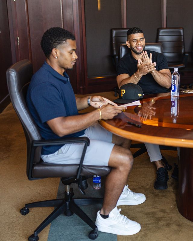 Pensacola Catholic graduate Chris Rembert signs with the Pittsburgh Pirates as his brother, Brandon, a team area supervisor, looks on July 22, 2026.