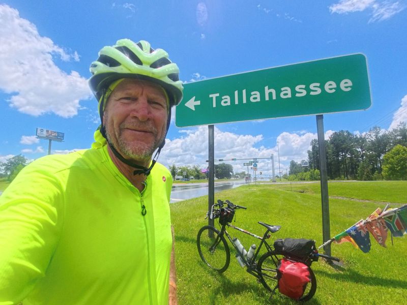 Tallahassee resident and Leon High tennis coach Kevin Record is scheduled to arrive in Tallahassee on Saturday, July 25, 2026 at noon at the Leon High tennis courts as he completes his cycling trek around the world.
