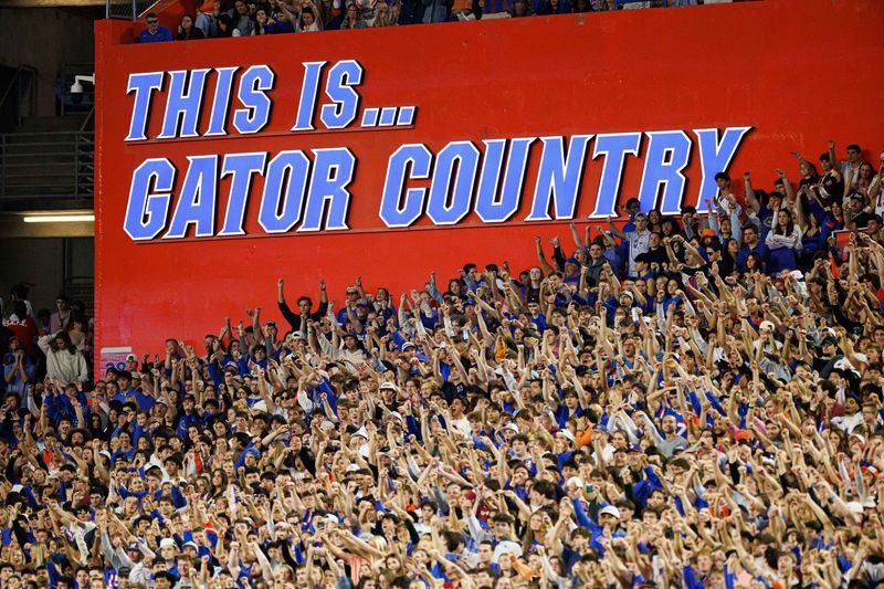 Nov 29, 2025; Gainesville, Florida, USA; A sign that reads This Is Gator Country is illuminated while fans cheer between the Florida Gators and Florida State Seminoles during the first half at Ben Hill Griffin Stadium. Mandatory Credit: Matt Pendleton-Imagn Images