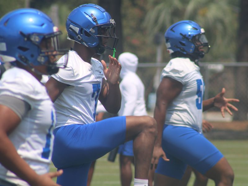 Trinity Christian linebacker/defensive back Terrell Pinkney (7) and teammates run through warm-ups for high school football practice.