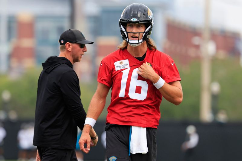 Jacksonville Jaguars quarterback Trevor Lawrence (16) looks on near head coach Liam Coen during the first day of NFL Training Camp at the Miller Electric Center on Wednesday, July 29, 2026, in Jacksonville, Fla.