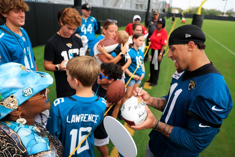 Jacksonville Jaguars wide receiver Parker Washington (11) signs autographs after the first day of NFL Training Camp at the Miller Electric Center on Wednesday, July 29, 2026, in Jacksonville, Fla.