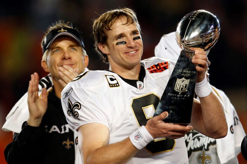 New Orleans Saints head coach Sean Payton applauds as quarterback Drew Brees holds up the Vince Lombardi trophy after defeating the Indianapolis Colts to win the NFL's Super Bowl XLIV football game in Miami, Florida in this February 7, 2010 file photo. Proposals to extend the National Football League (NFL) season by two games have not been thought through and could lead to more injuries and curtailed careers, say players. Picture taken February 7, 2010. To match Feature NFL-SCHEDULE.  REUTERS/Jeff Haynes (UNITED STATES - Tags: SPORT FOOTBALL)