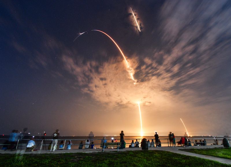 Spectators at Kennedy Point Park in Titusville watch the Launch and booster landing of a SpaceX Falcon 9 rocket carrying a national security payload designed, built and operated by the National Reconnaissance Organization. Rocket launches at 3:10 a.m. Thursday, July 30 from Launch Complex 40 at Cape Canaveral Space Force Station with the booster returning about eight minutes later.