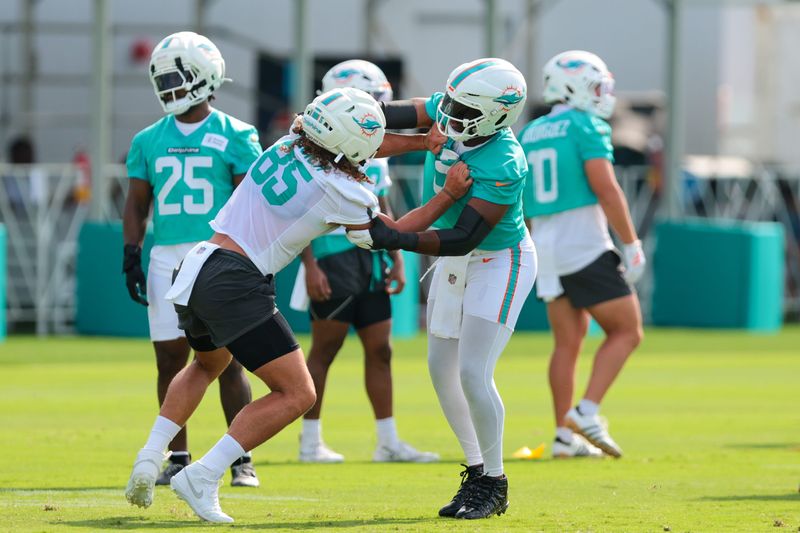 Jul 30, 2026; Miami Gardens, FL, USA; Miami Dolphins tight end Greg Dulcich (85) works with edge Josh Uche (9) during practice at Baptist Health Training Complex. Mandatory Credit: Sam Navarro-Imagn Images
