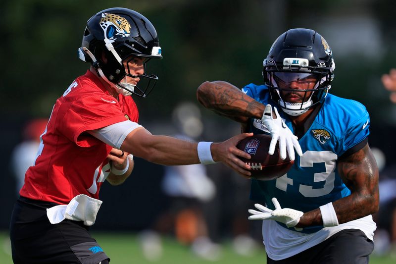 Jacksonville Jaguars quarterback Nick Mullens (14) hands off to running back Ameer Abdullah (43) during the third day of NFL Training Camp at the Miller Electric Center on Friday, July 31, 2026, in Jacksonville, Fla.
