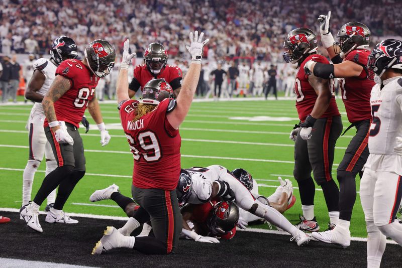 Sep 15, 2025; Houston, Texas, USA; Tampa Bay Buccaneers guard Cody Mauch (69) celebrates as Tampa Bay Buccaneers running back Rachaad White (1) scores a touchdown  during the fourth quarter against the Houston Texans at NRG Stadium. Mandatory Credit: Thomas Shea-Imagn Images