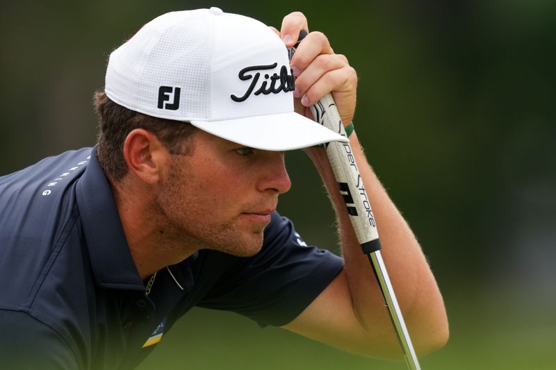 Aug 1, 2026; Detroit, Michigan, USA;  Michael Brennan lines up a putt on the sixth green during the third round of the Rocket Classic golf tournament. Mandatory Credit: Aaron Doster-Imagn Images