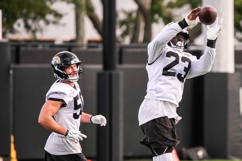 Jacksonville Jaguars Linebacker Foyesade Oluokun (23) intercepts a pass while running a drill with Jacksonville Jaguars Linebacker Branson Combs (50) during the fourth day of NFL Training Camp in shells at the Miller Electric Center on Thursday, July 30, 2026, in Jacksonville, Fla.  [Doug Engle/Florida Times-Union]