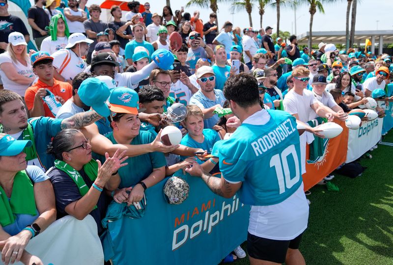 Miami Dolphins linebacker Jacob Rodriguez (10) signs autographs for fans at training camp at Baptist Health Training Complex, Sunday, August 2, 2026 in Miami Gardens, FL.