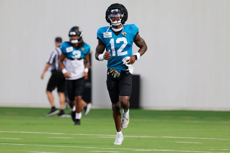 Jacksonville Jaguars wide receiver/cornerback Travis Hunter (12) runs on the field during the fifth day of NFL training camp at the Miller Electric Center on Monday, Aug. 3, 2026, in Jacksonville, Fla. Today marked the first full‑pads practice. [Corey Perrine/Florida Times-Union]