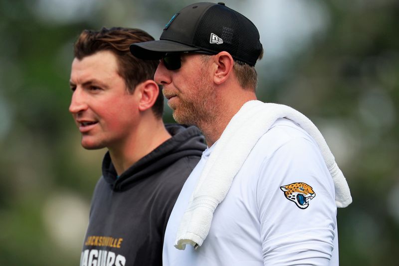 Jacksonville Jaguars offensive coordinator Grant Udinski, left, and head coach Liam Coen talk as they walk off the field after the sixth day of NFL training camp at the Miller Electric Center on Tuesday, Aug. 4, 2026, in Jacksonville, Fla.