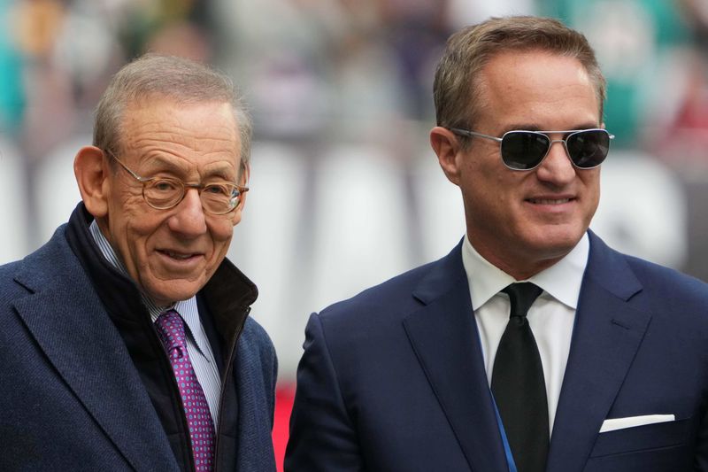 Oct 17, 2021; London, England, United Kingdom; Miami Dolphins owner Stephen Ross (left) and chief executive officer Tom Garfinkel watch during an NFL International Series game against the Jacksonville Jaguars at Tottenham Hotspur Stadium. The Jaguars defeated the Dolphins 23-20. Mandatory Credit: Kirby Lee-USA TODAY Sports