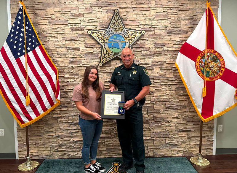 ECSO Sheriff Chip Simmons awards Emily Shelton a Sheriff's Medal after making heart-pounding emergency landing on Interstate 10.