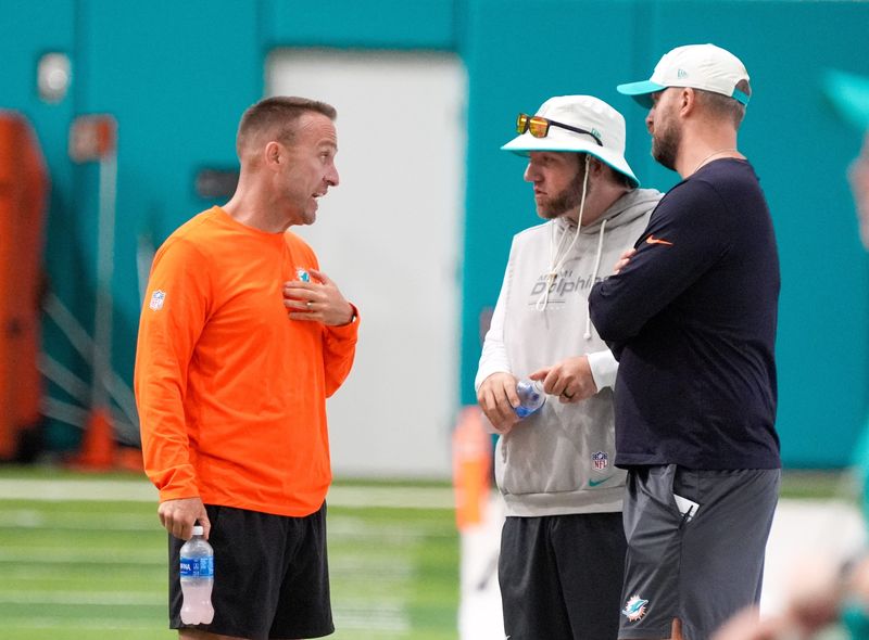 Miami Dolphins head coach Jeff Hafley talks with defensive line coach Austin Clark and defensive coordinator Sean Duggan at training camp at Baptist Health Training Complex, Sunday, August 2, 2026 in Miami Gardens, FL.