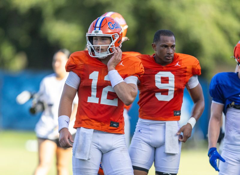 Florida quarterbacks Aaron Philo (12) and J. Tramell Jones Jr. (9) practice during Florida Football Fall camp availability at Heavener Football Training Center in Gainesville, FL on Friday, August 7, 2026. [Alan Youngblood/Gainesville Sun]