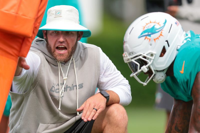 Aug 3, 2026; Miami Gardens, FL, USA; Miami Dolphins defensive line coach Austin Clark works with his players during practice at Baptist Health Training Complex. Mandatory Credit: Sam Navarro-Imagn Images