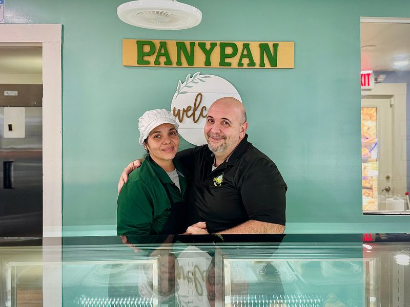 Adrina and Jaime De Sa, owners of Panypan Bakery, pose for a photo inside the Orange City shop.