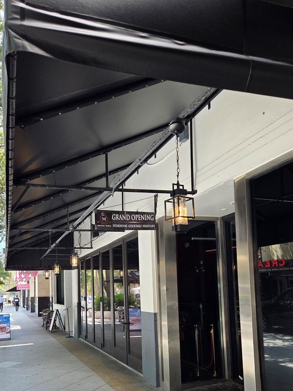 For now, a grand opening shingle dangles outside Mystic Table at 218 Clematis Street in downtown West Palm Beach.