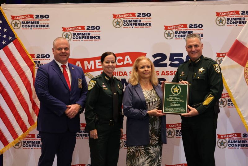 Clay County Sheriff's victim advocate Ilka Roncone, second from right, receives the 2026 Florida Sheriffs Association Civilian of the Year award from President Dennis Lemma, right. From left are Gulf County Sheriff Mike Harrison and Clay County Sheriff Michelle Cook.