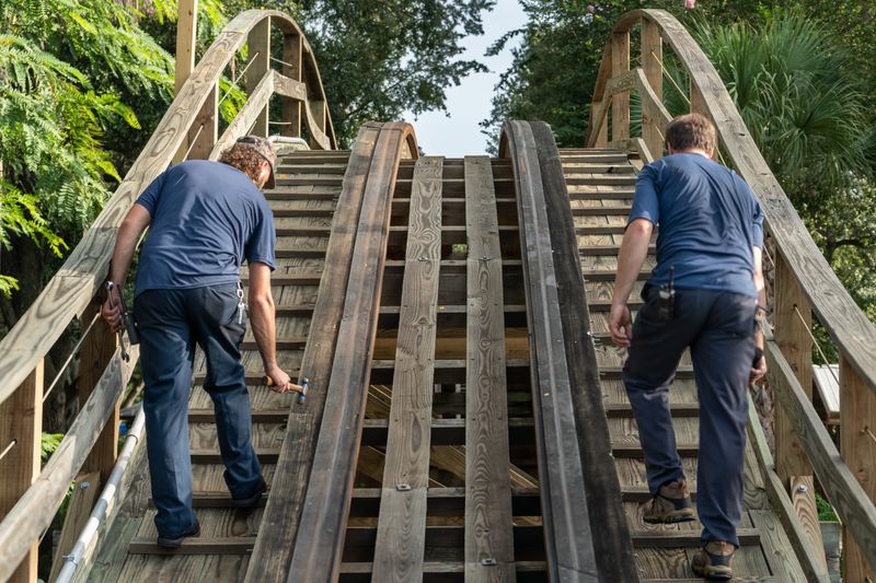 Workers are shown making repairs to the wooden structure of Coastersaurus, a roller coaster at Legoland Florida Resort in Winter Haven. The ride, closed since January, will reopen Aug. 16.