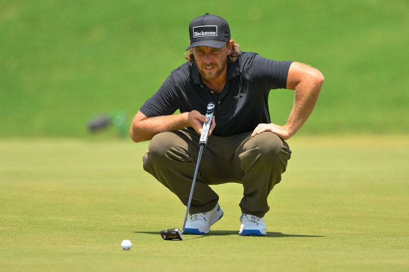 Aug 14, 2026; Memphis, Tennessee, USA; Tommy Fleetwood looks over his second putt on the ninth green during the second round of the FedEx St. Jude Championship golf tournament. Mandatory Credit: Steve Roberts-Imagn Images