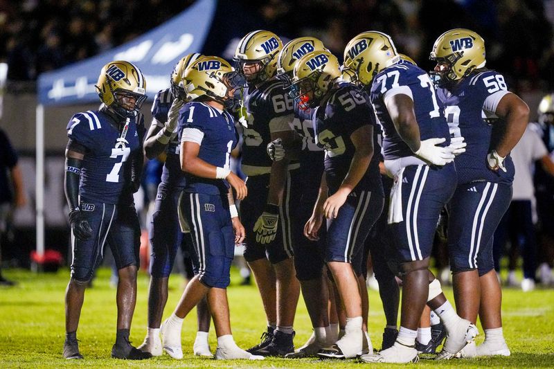 West Boca quarterback Trey Moran (1) huddles with his team in a game against Carol City during the fourth quarter on Aug. 14, 2026, in Boca Raton, FL.