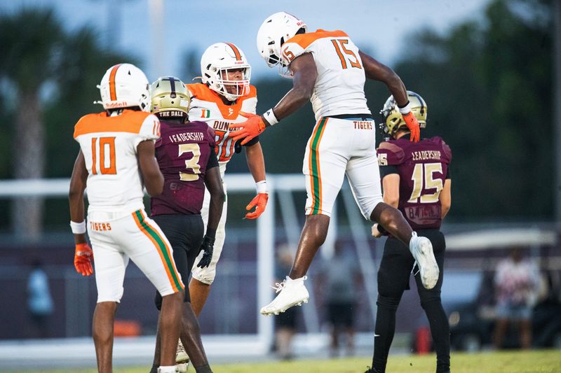 Members of the Dunbar High School football team react during a preseason game against Riverdale at Riverdale on Friday, Aug. 14, 2026. Riverdale would recover the ball and score.